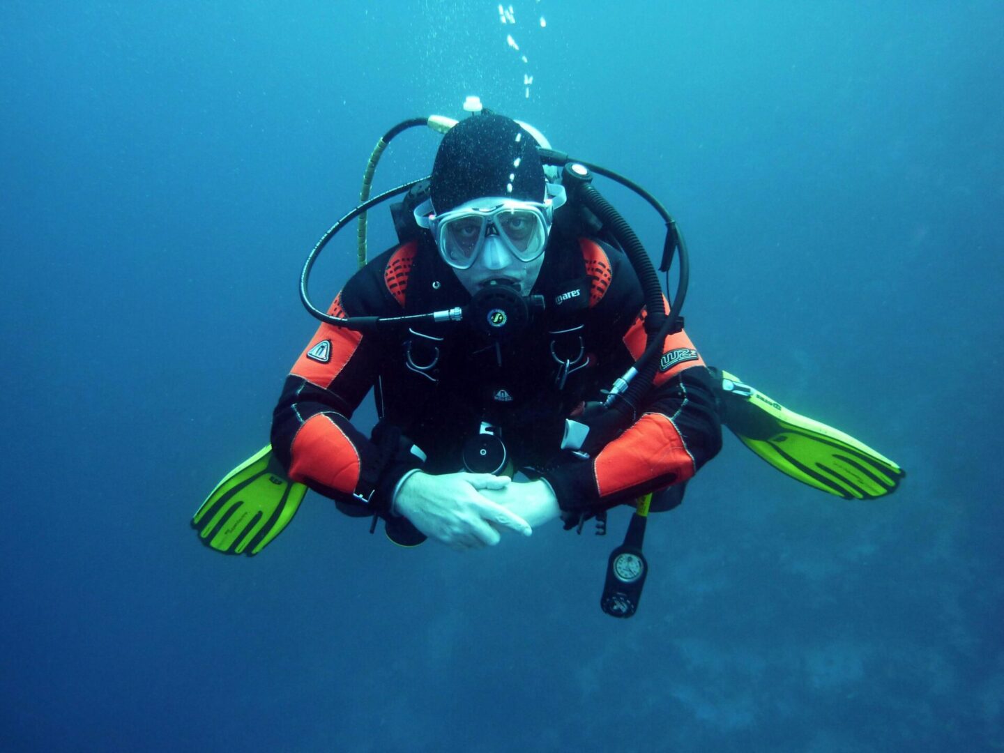 A scuba diver is sitting in the water.